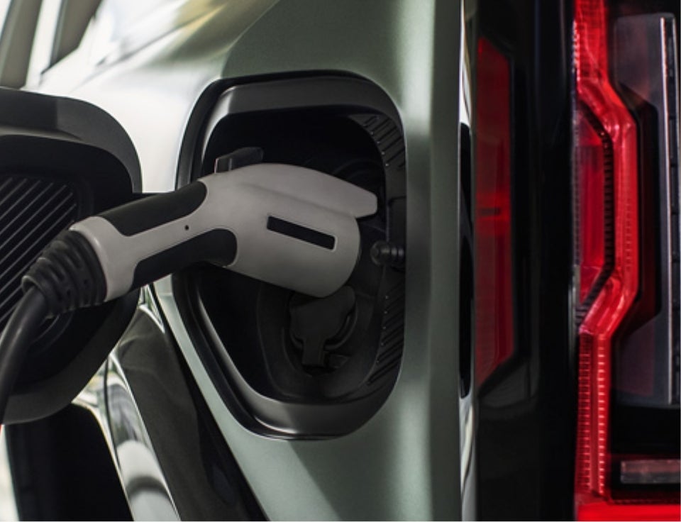 Close up of charging port with charger plugged in on a GMC Hummer EV SUV - Hall Motor Company GMC in LAKEVIEW OR
